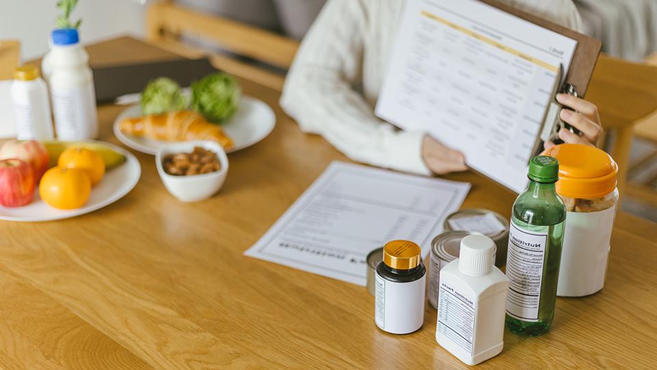 A student displays information about the nutritious food on a table.